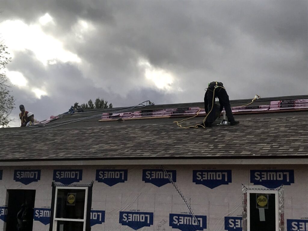 student working on roof