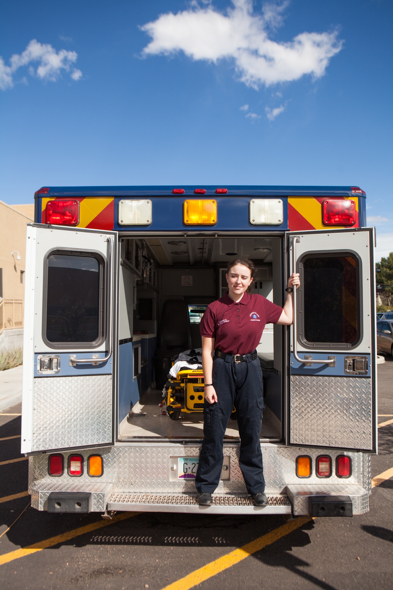 female student standing in an ambulance