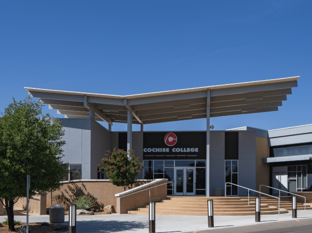 Front entrance to new building. Modern architecture with glass doors and tall windows.