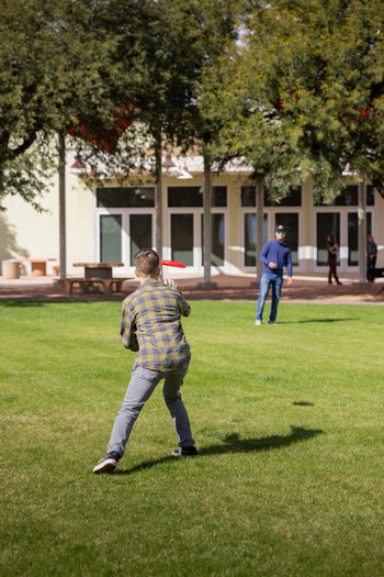 Two Students Playing Frisbee