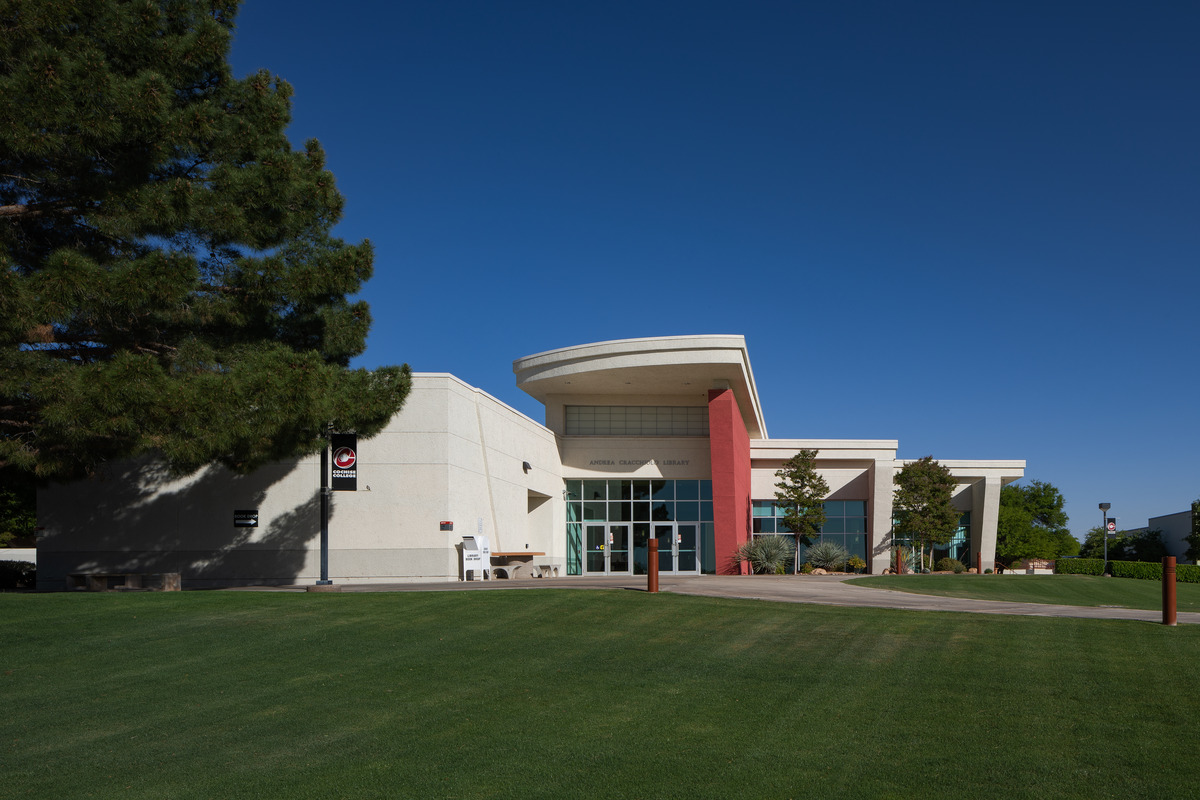 Front entrance to new building. Modern architecture with glass doors and tall windows.