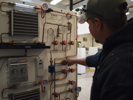 HVAC instructor working on a machine.