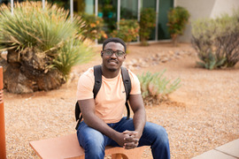 Male sitting outside science building on Sierra Vista Campus