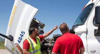 Instructor and student looking at an engine